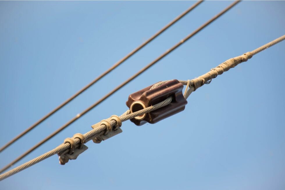 a brown Stay Insulator on overhead power lines