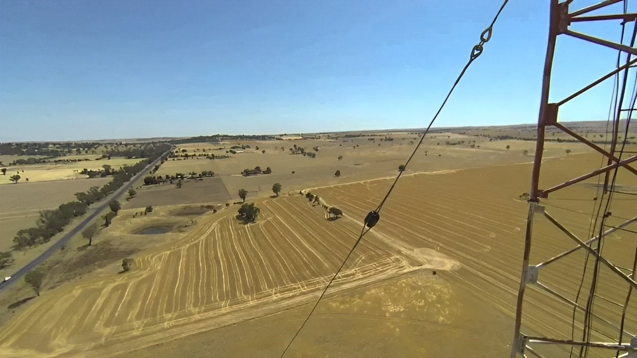 a utility pole featuring pole line hardware, including wires and insulators