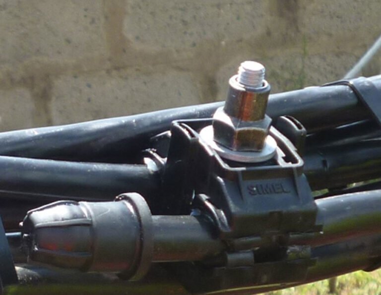 an insulation piercing connector facilitating an electrical connection between multiple black cables.