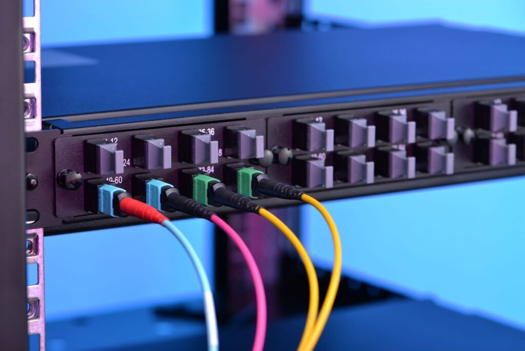 MPO/MTP connectivity in a data center rack, showing several colorful fiber optic cables connected to patch panels