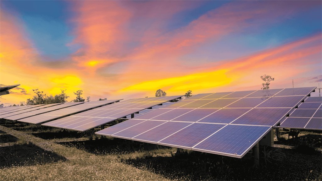 Solar panels at sunset, capturing the warm glow of the sky