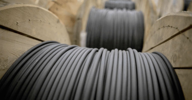 large wooden spools holding black Outdoor Fiber Cables