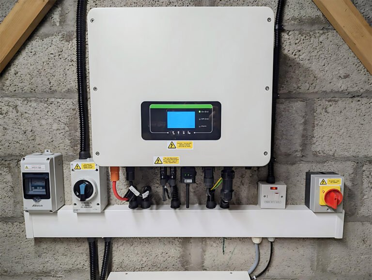 one of Electric Inverters and various electrical components are installed on a gray concrete block wall